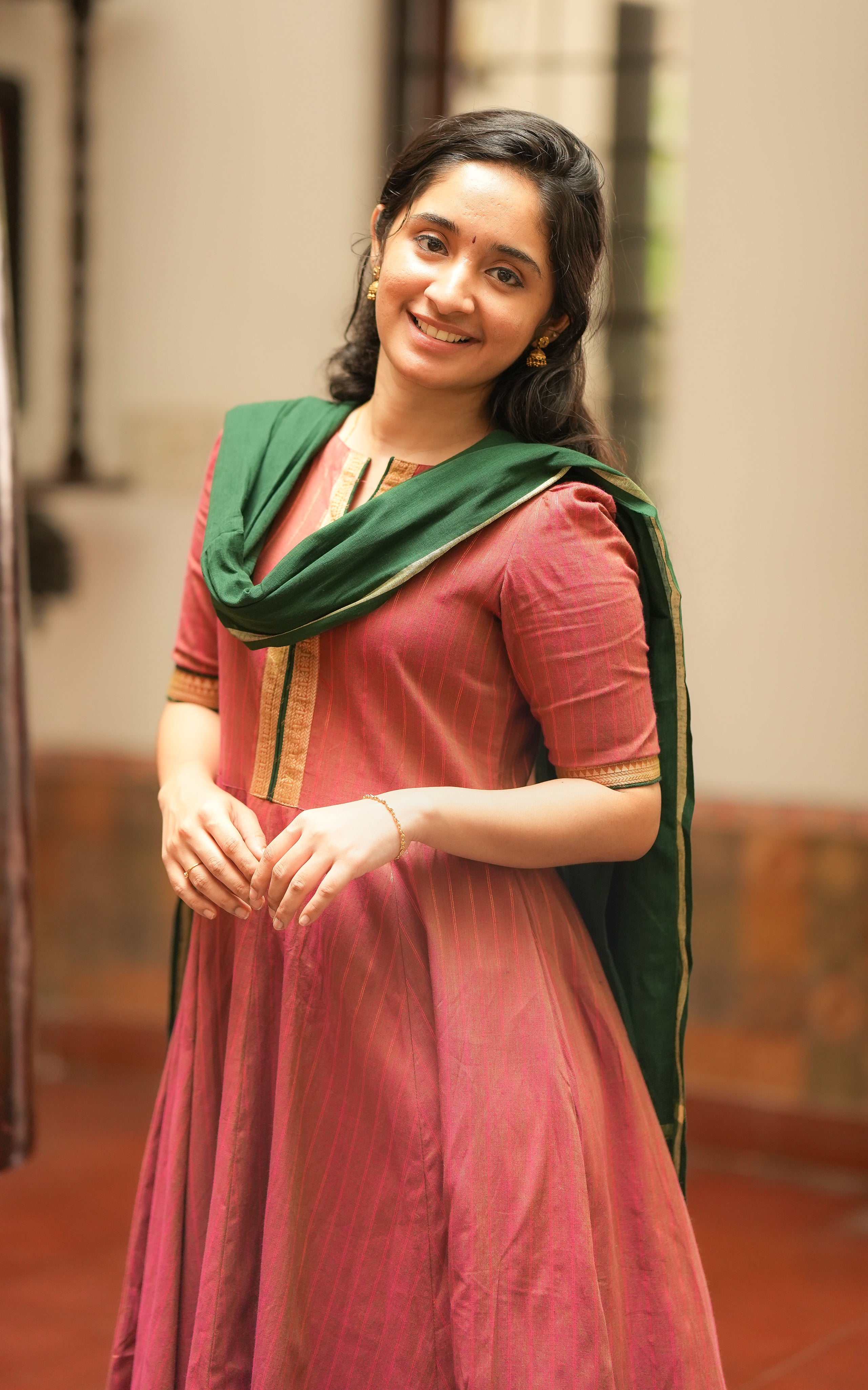 The kurti features vertical golden thread stripes, as seen in Annapoorani.