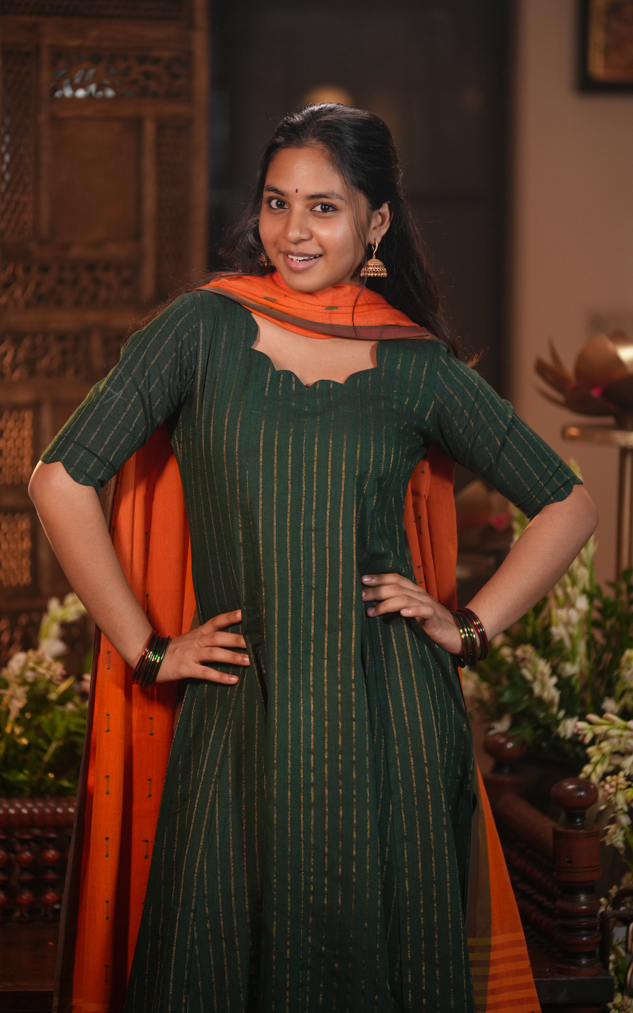 The kurti has elbow-length sleeves and a flared, floor-length hemline.