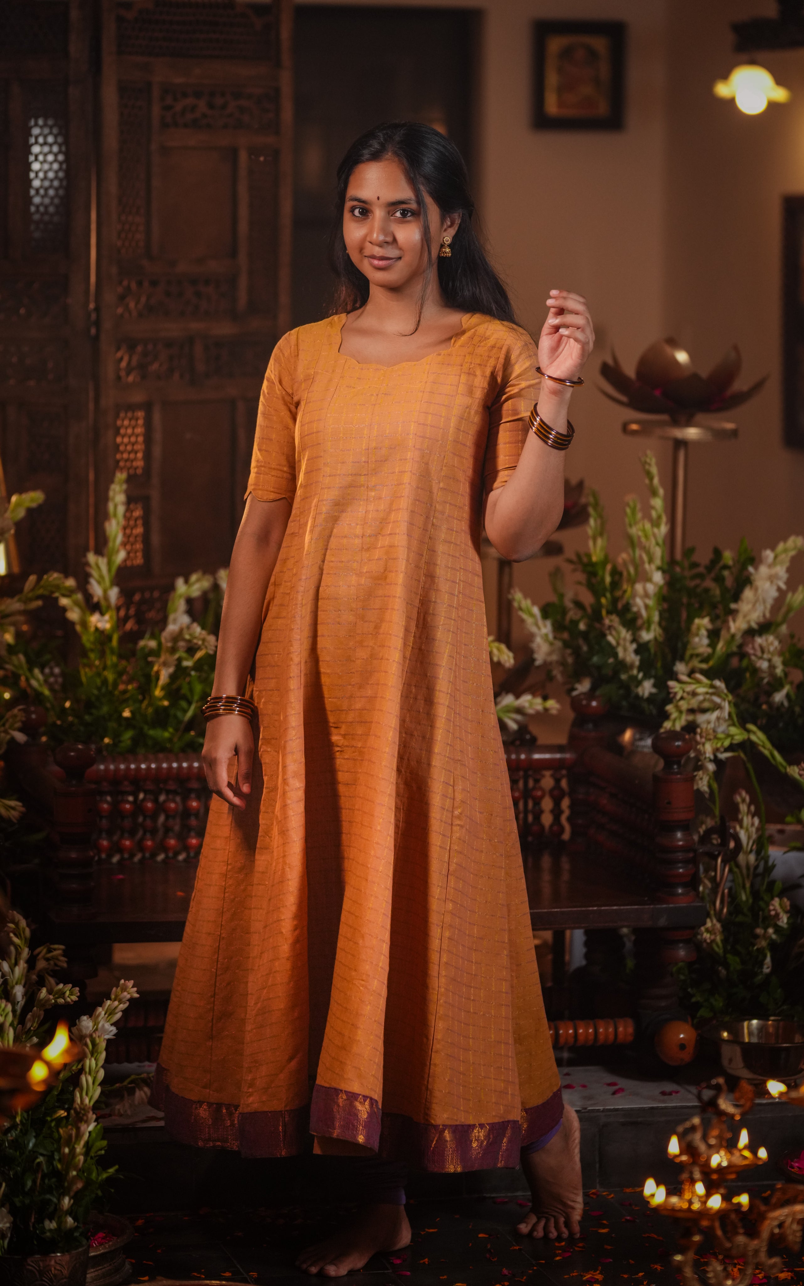 The garment flows into a flared silhouette, perfect for festive occasions.