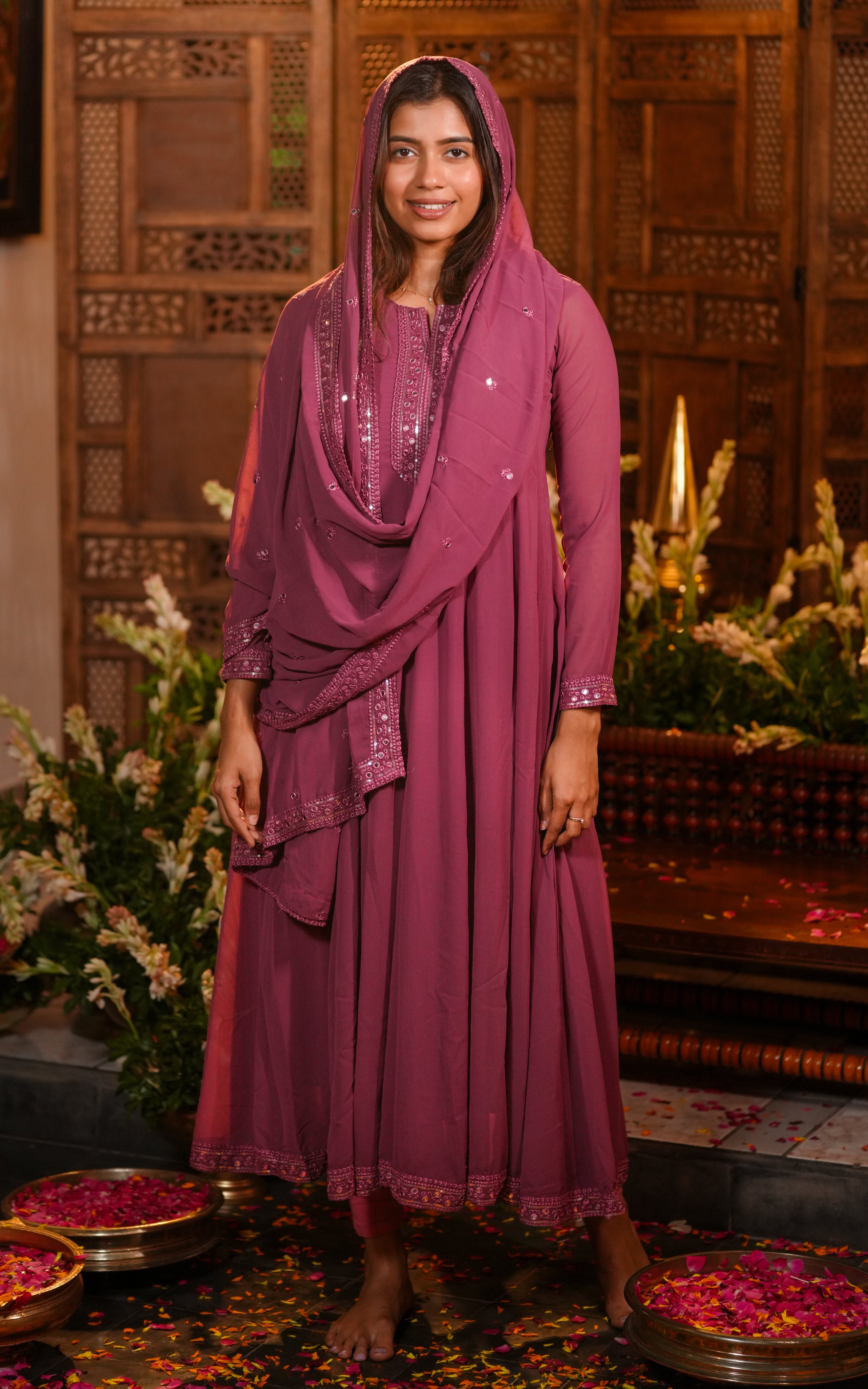 The outfit is paired with a sequin-embroidered dupatta in matching onion pink georgette.