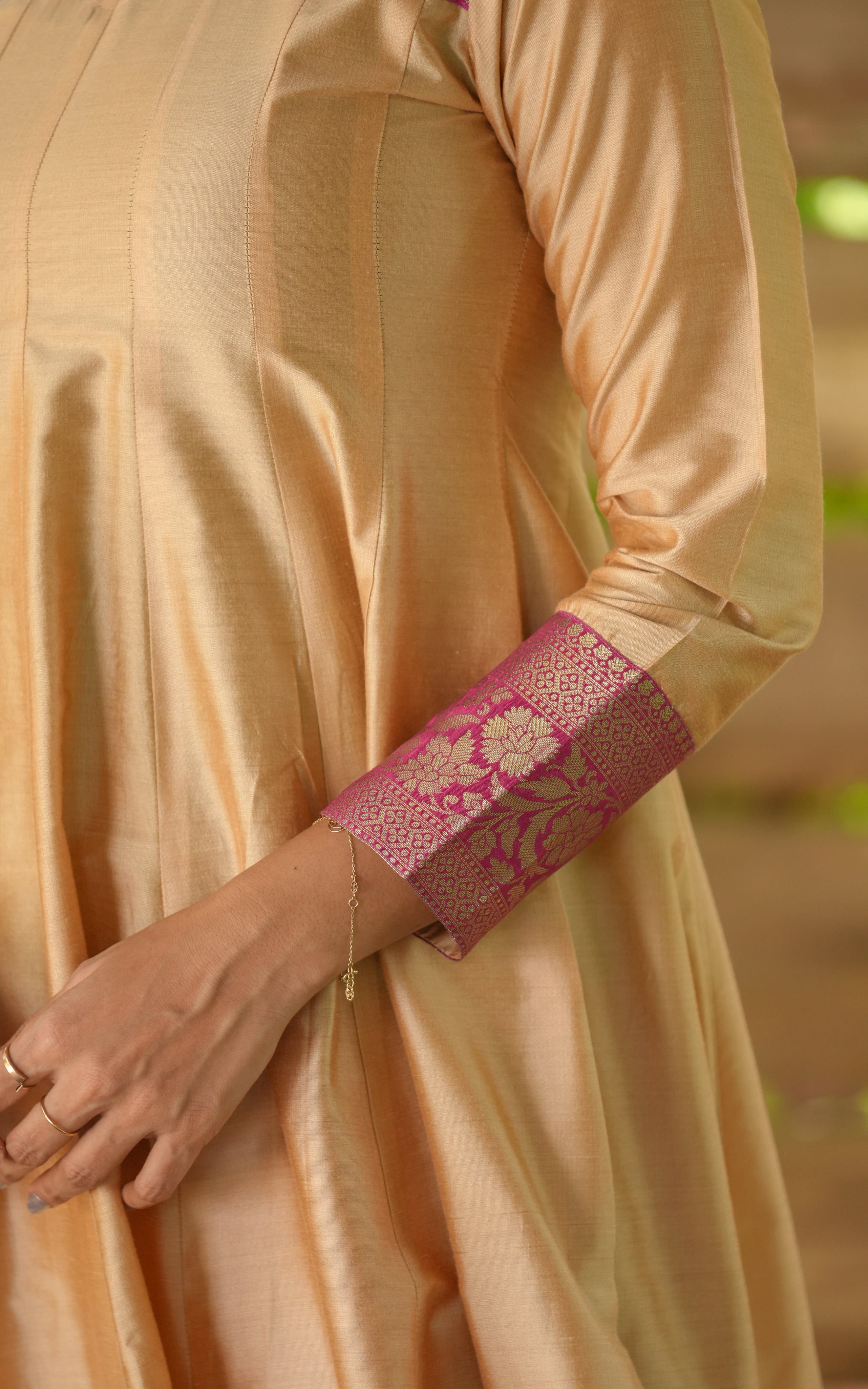 Beige kurta with pink and gold zari on sleeve