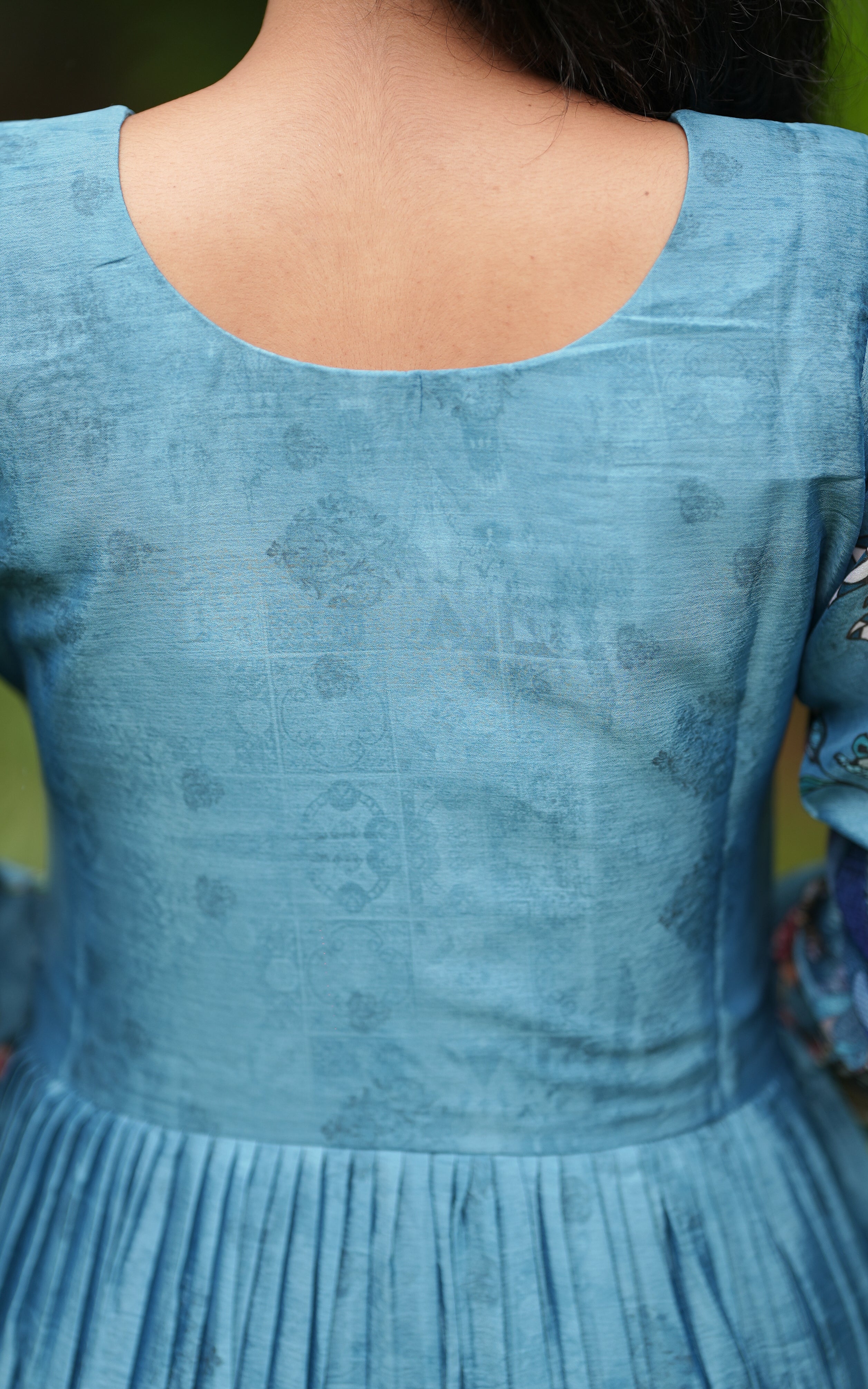 Back neckline features a modest round shape