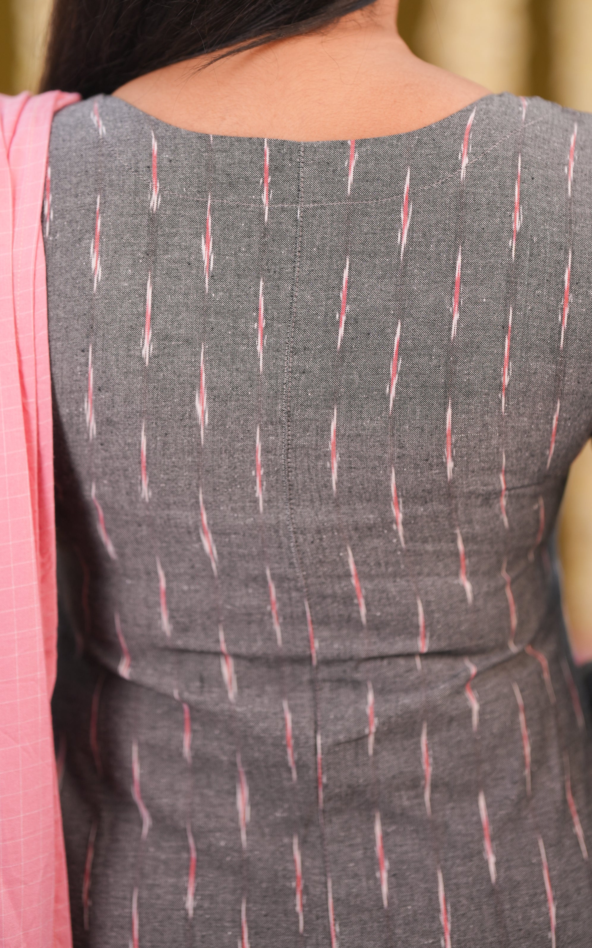 An elegant straight cut kurti with side slits ,featuring a loose and comfortable fit that falls gracefully to mid-thigh The kurti has 3/4 th sleeves and a simple round neckline with tie knots with add a stylish touch to the design.