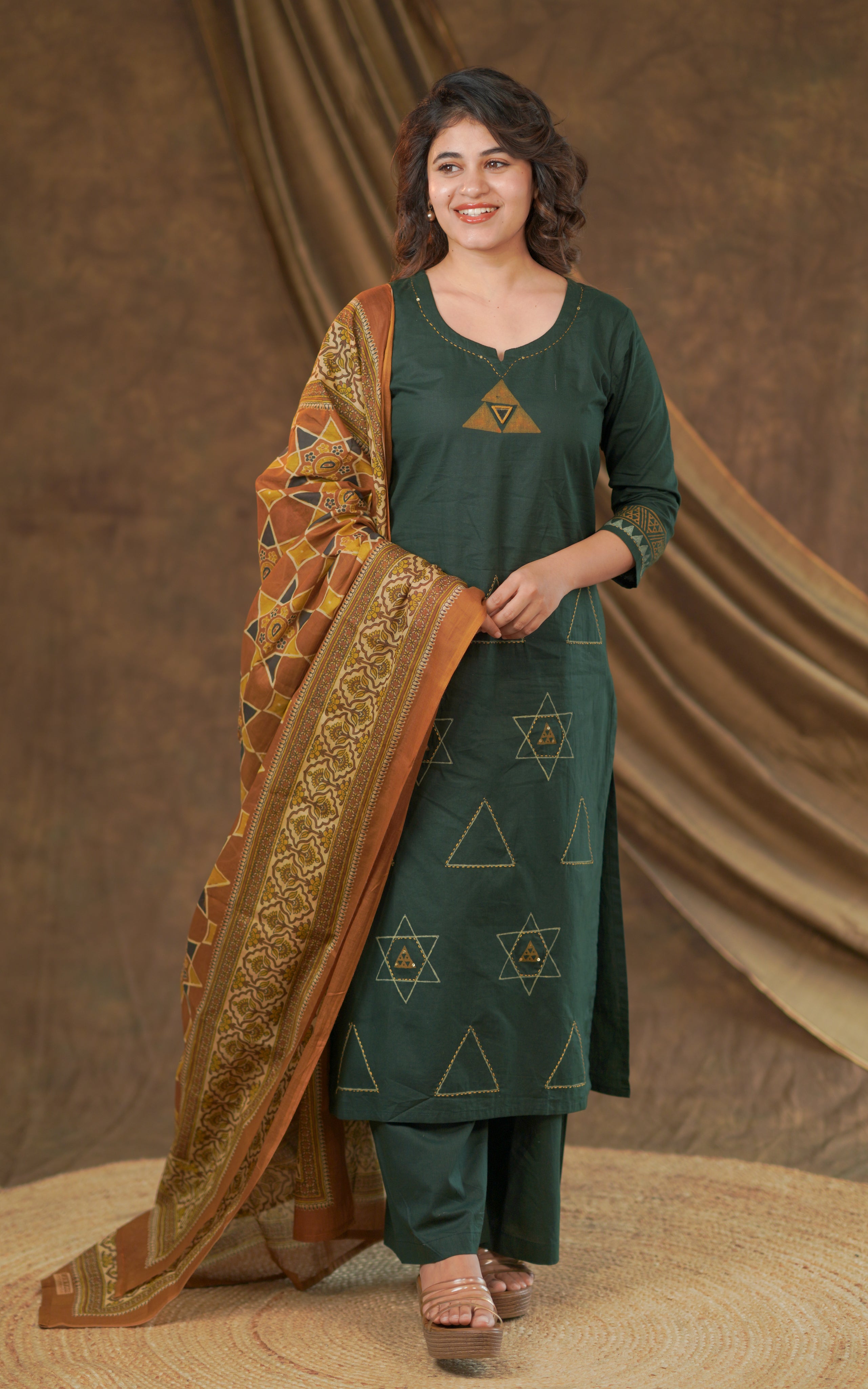 Deep green straight-cut kurta featuring geometric triangle motifs for a bold contemporary ethnic look.