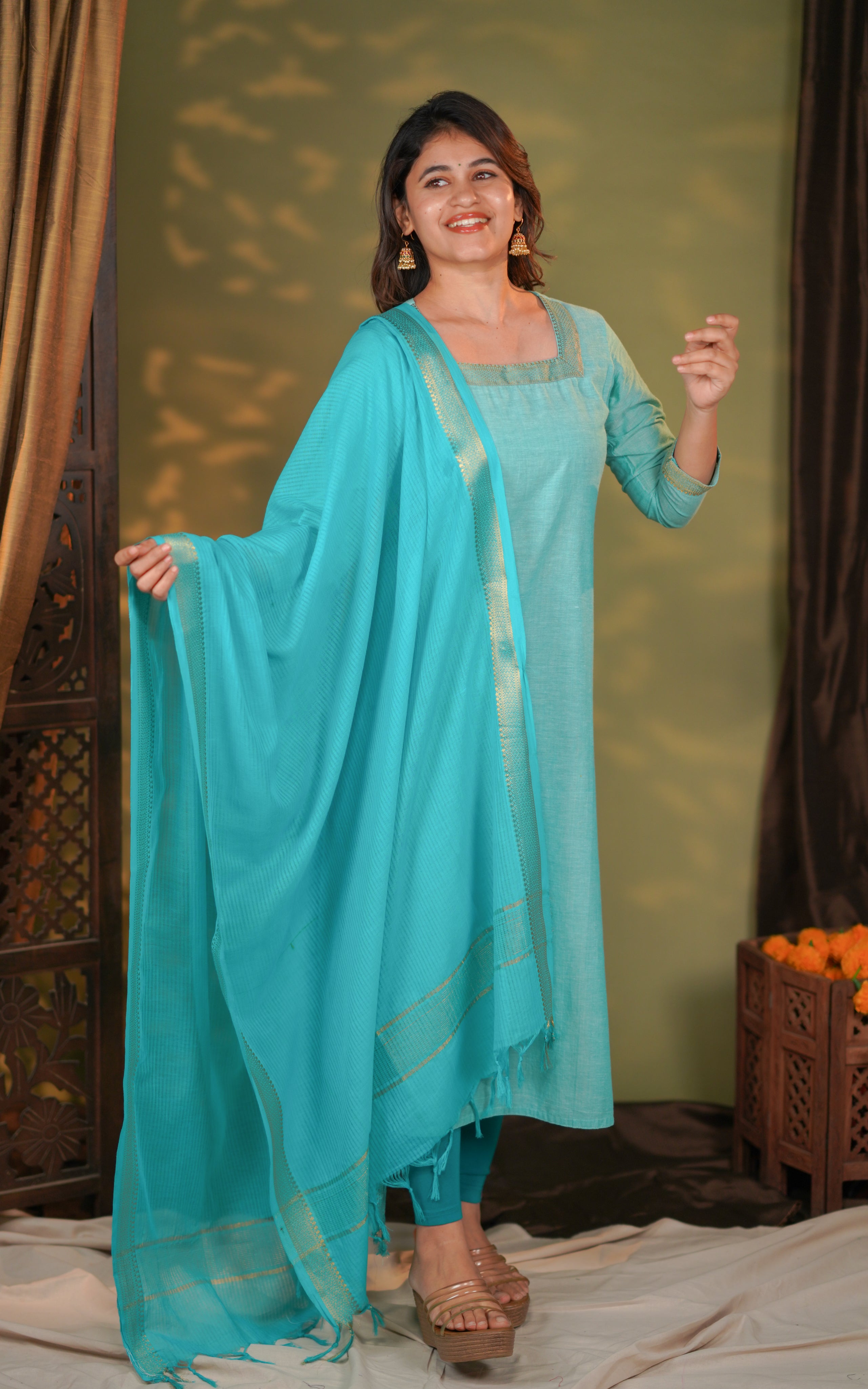 Woman in a turquoise traditional outfit