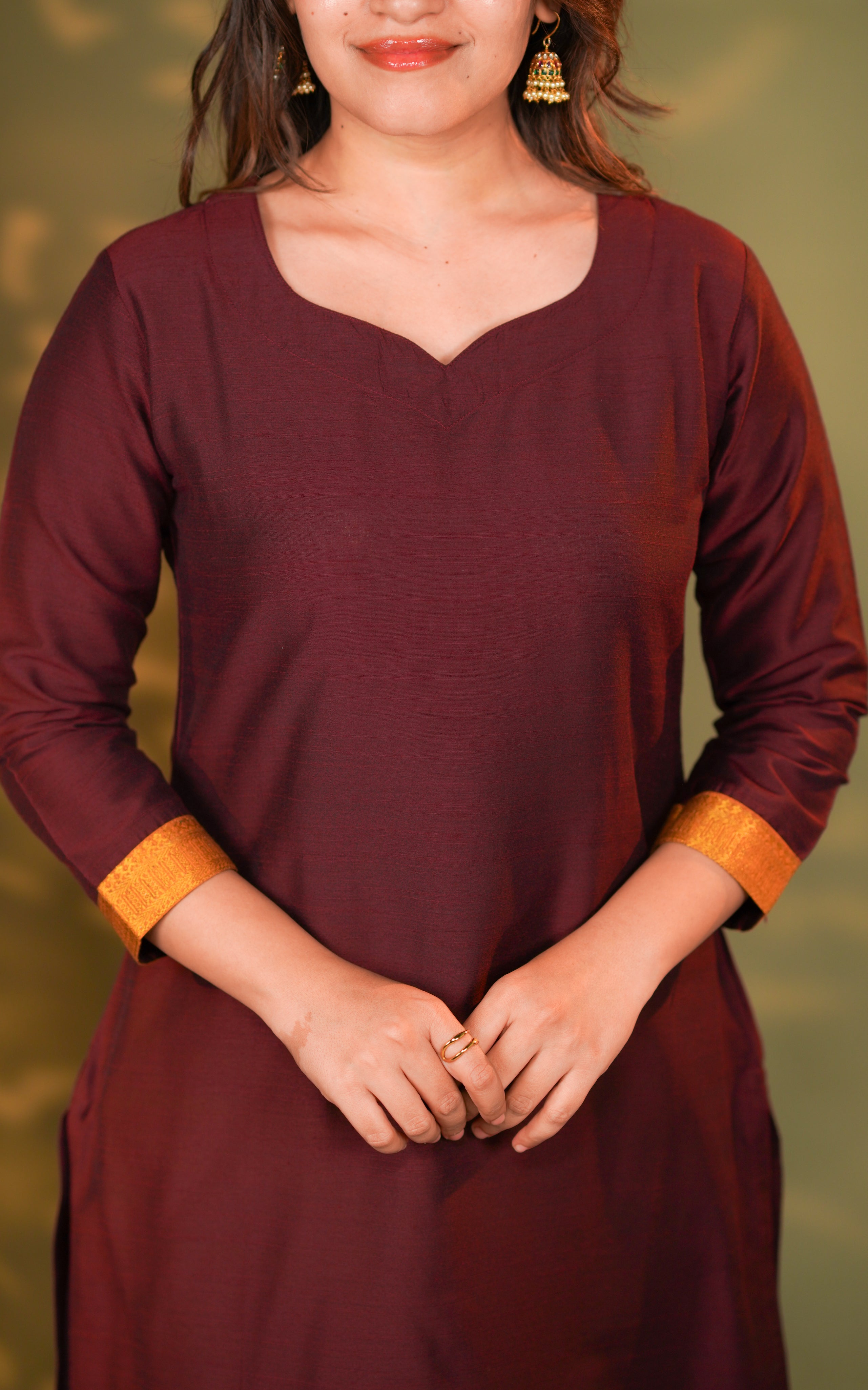 maroon tone provides a classy and versatile appearance suitable for office, casual, and festive styling. The fabric has a soft sheen that elevates the overall premium finish. The straight-cut design pairs perfectly with leggings or fitted pants for a balanced look.