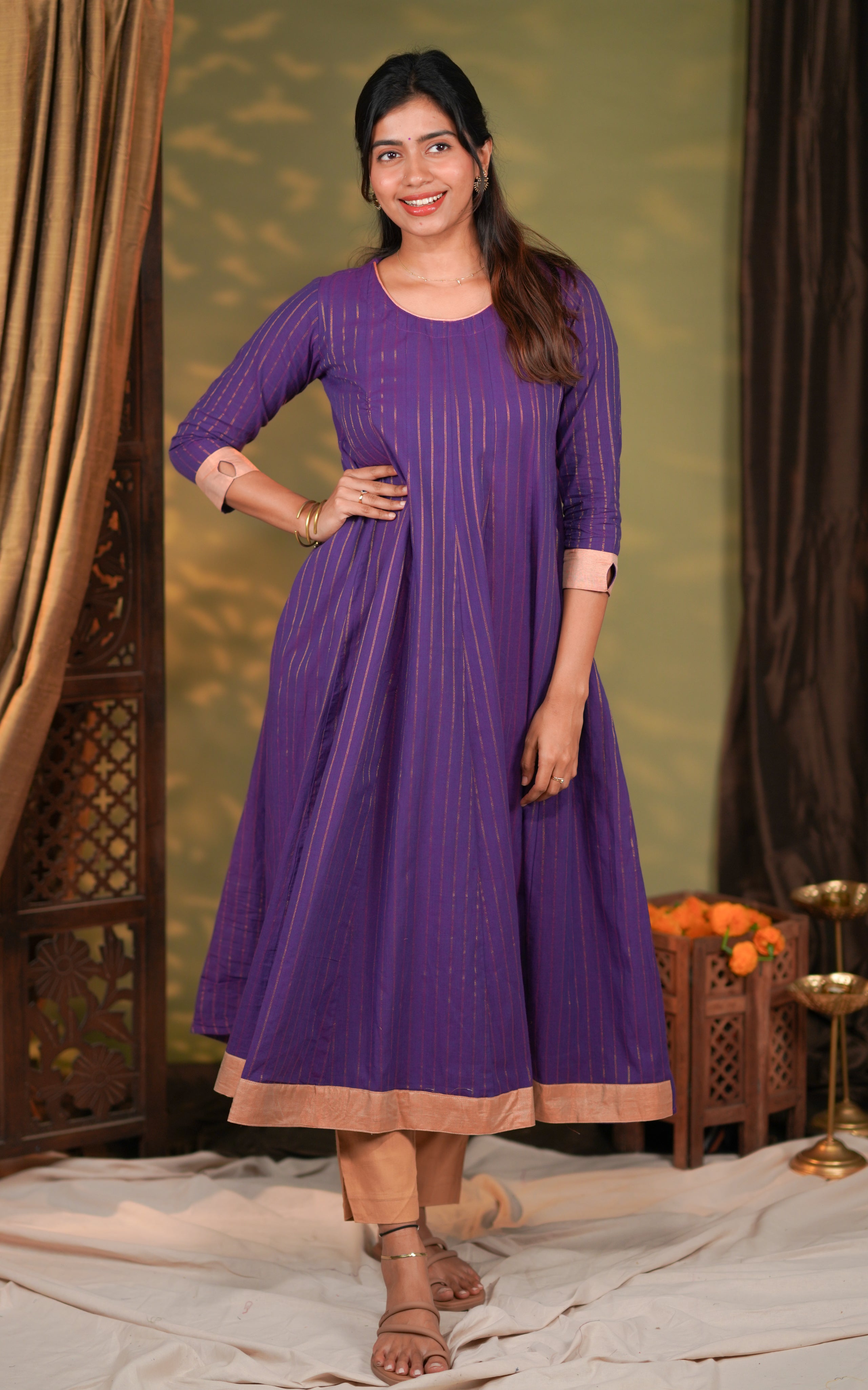 neckline is a rounded U-shape, giving the dress a simple yet stylish finish. The sleeves are three-fourth length with a soft beige contrast cuff for added detailing