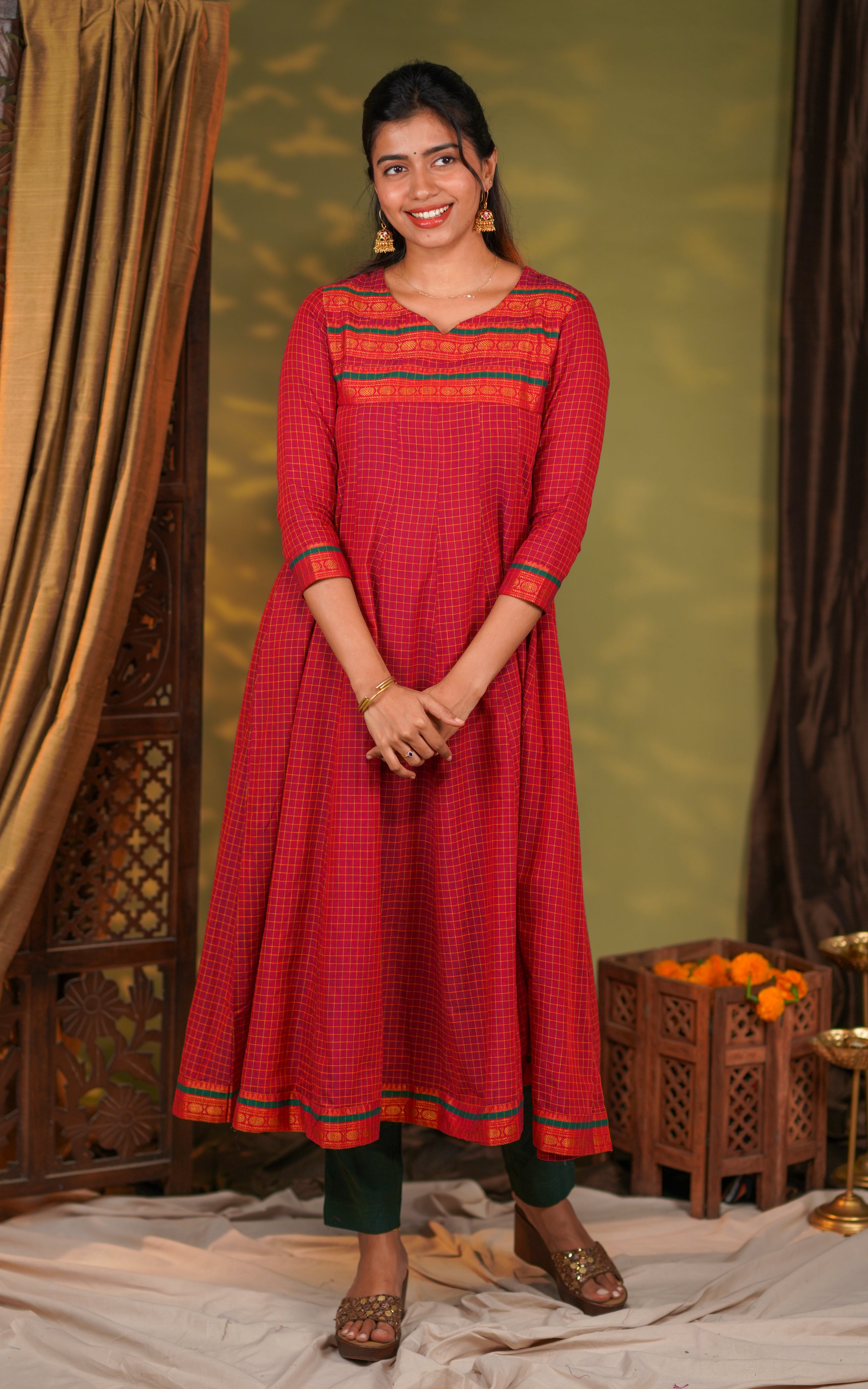 a beautifully flared Anarkali silhouette for graceful movement. The hemline is highlighted with a detailed zari border, giving the outfit a luxurious traditional touch