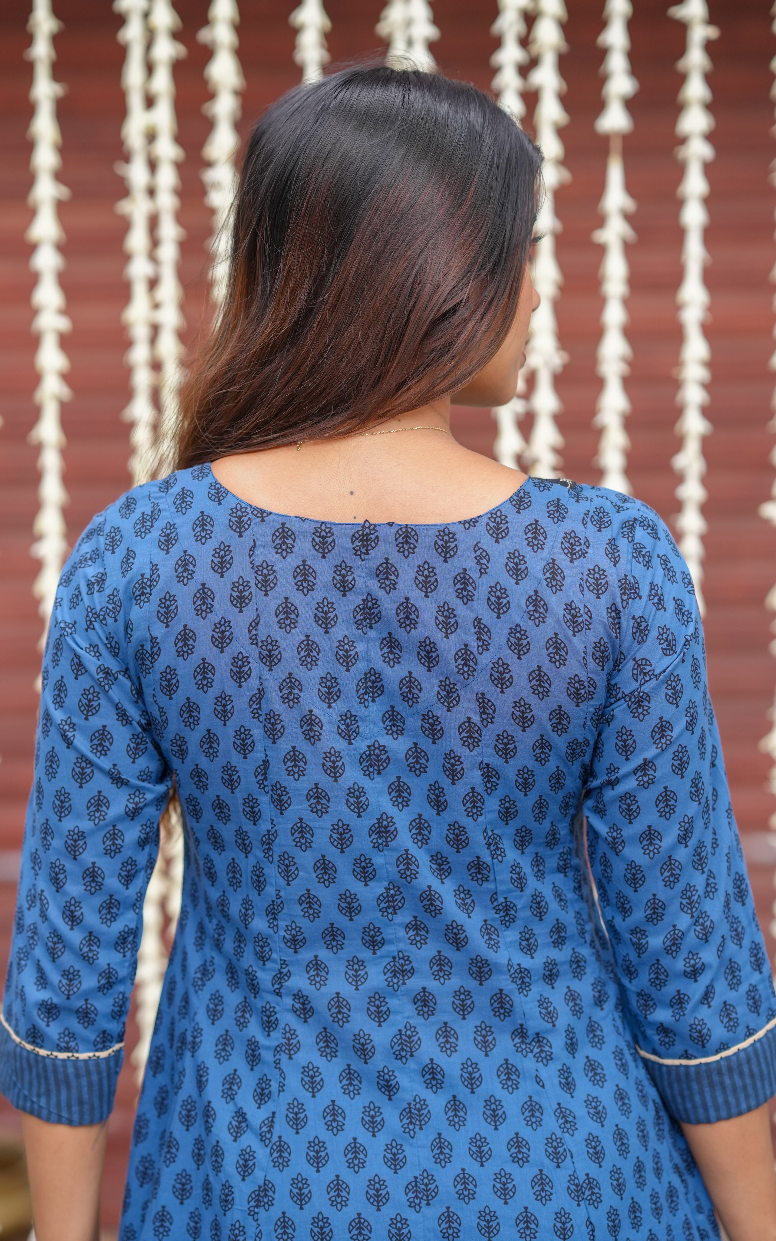 Back neckline features a modest round shape