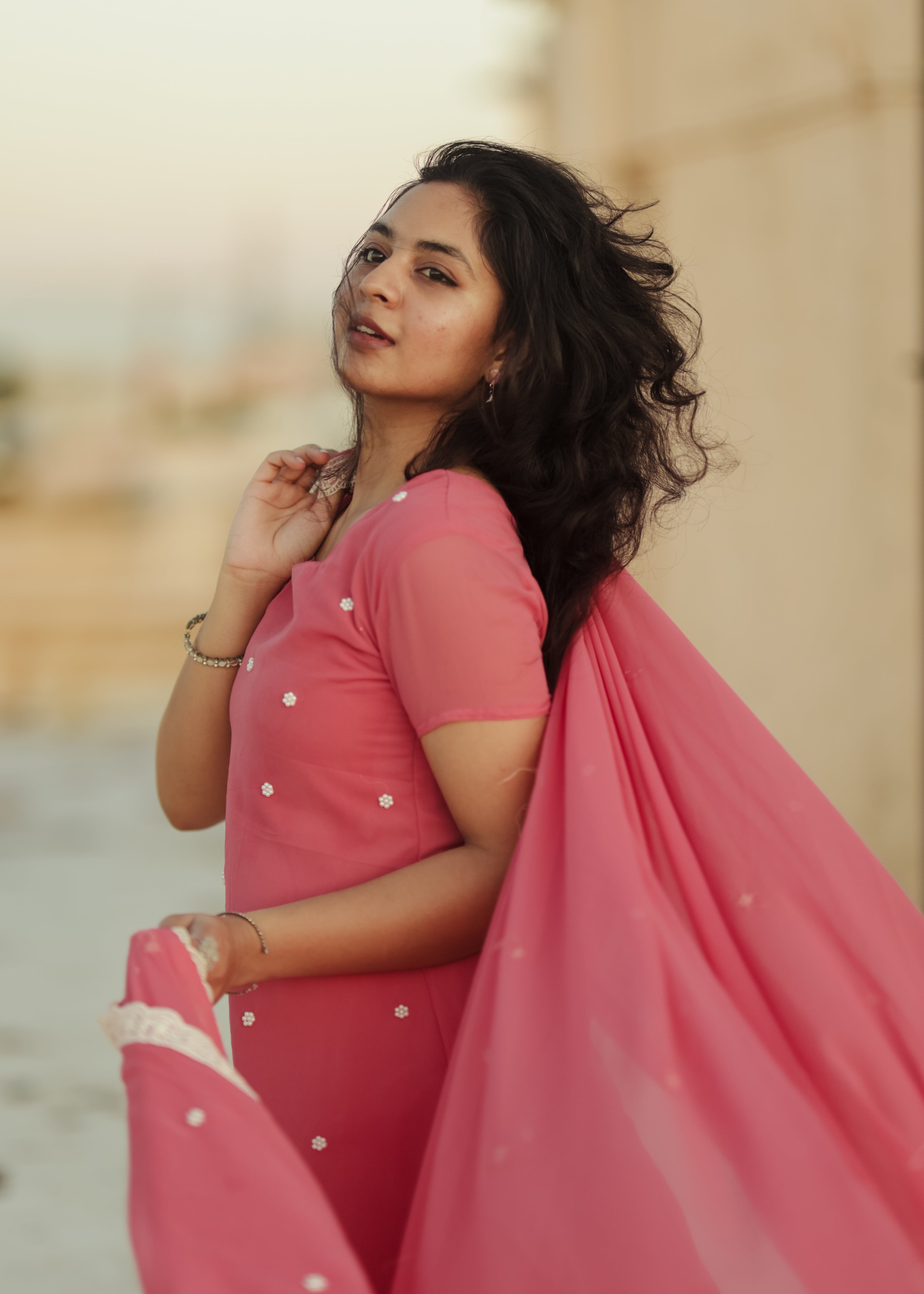 The kurti has short sleeves and a simple round neckline, with slits on both sides that add a stylish touch to the design.