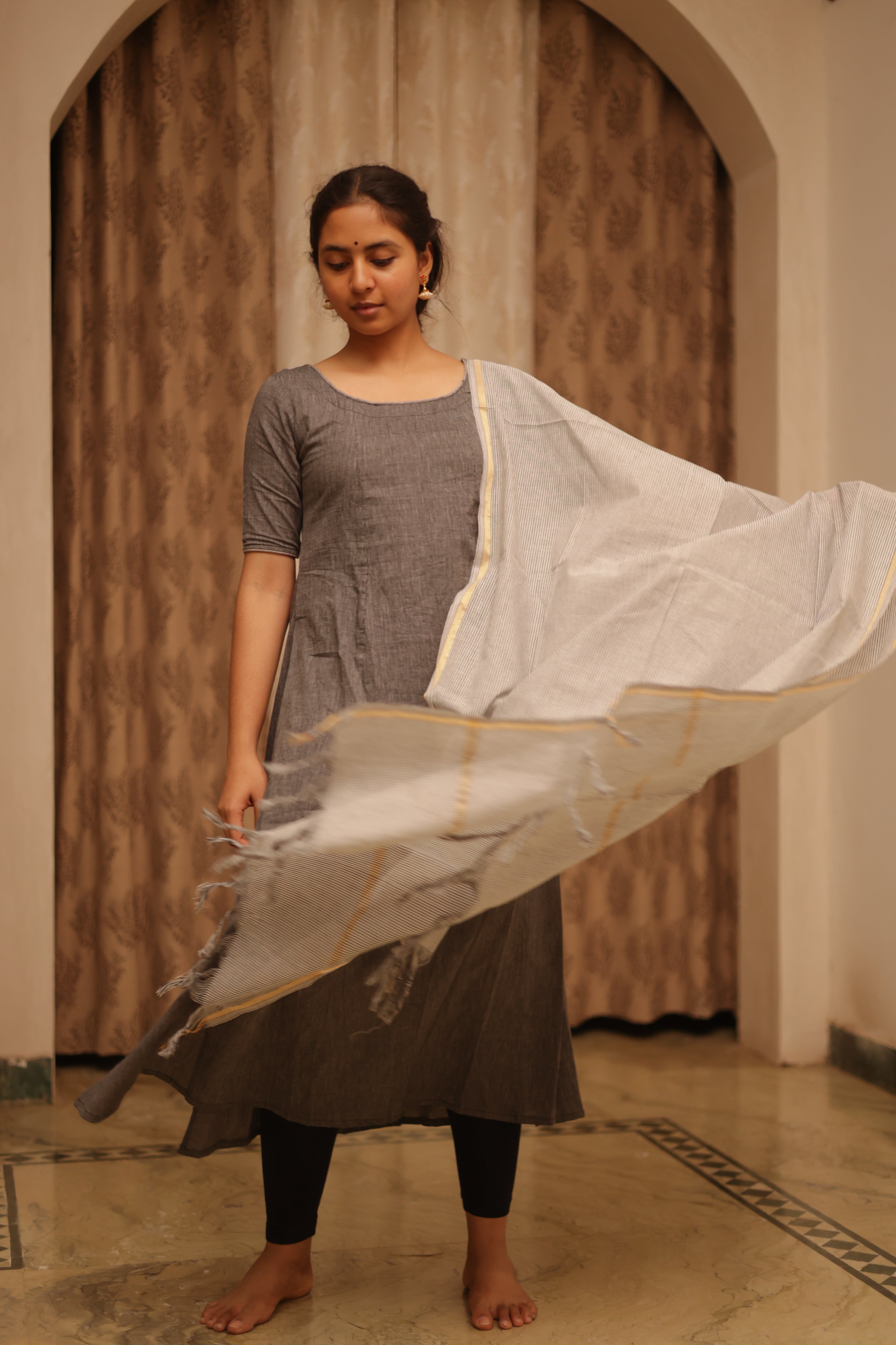 color combination of sandal and brown offers a warm, earthy vibe, making it both elegant and versatile,3/4th sleeves add a balanced touch,outfit includes a handloom cotton dupatta,enhanced with back knots, adding a modern, trendy look