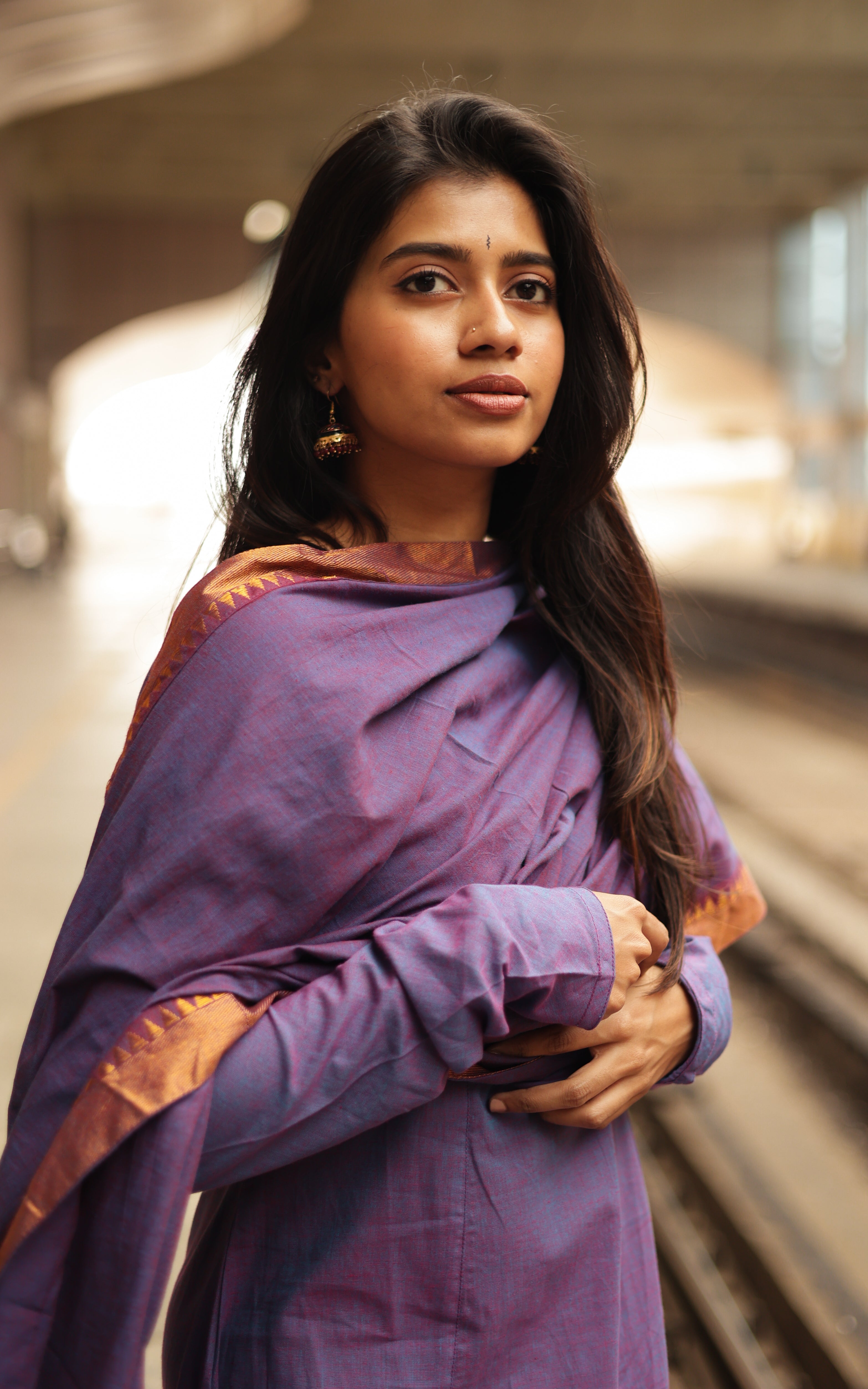 A south cotton dupatta in a neutral shade, elegantly framed with a vibrant mangalagiri border