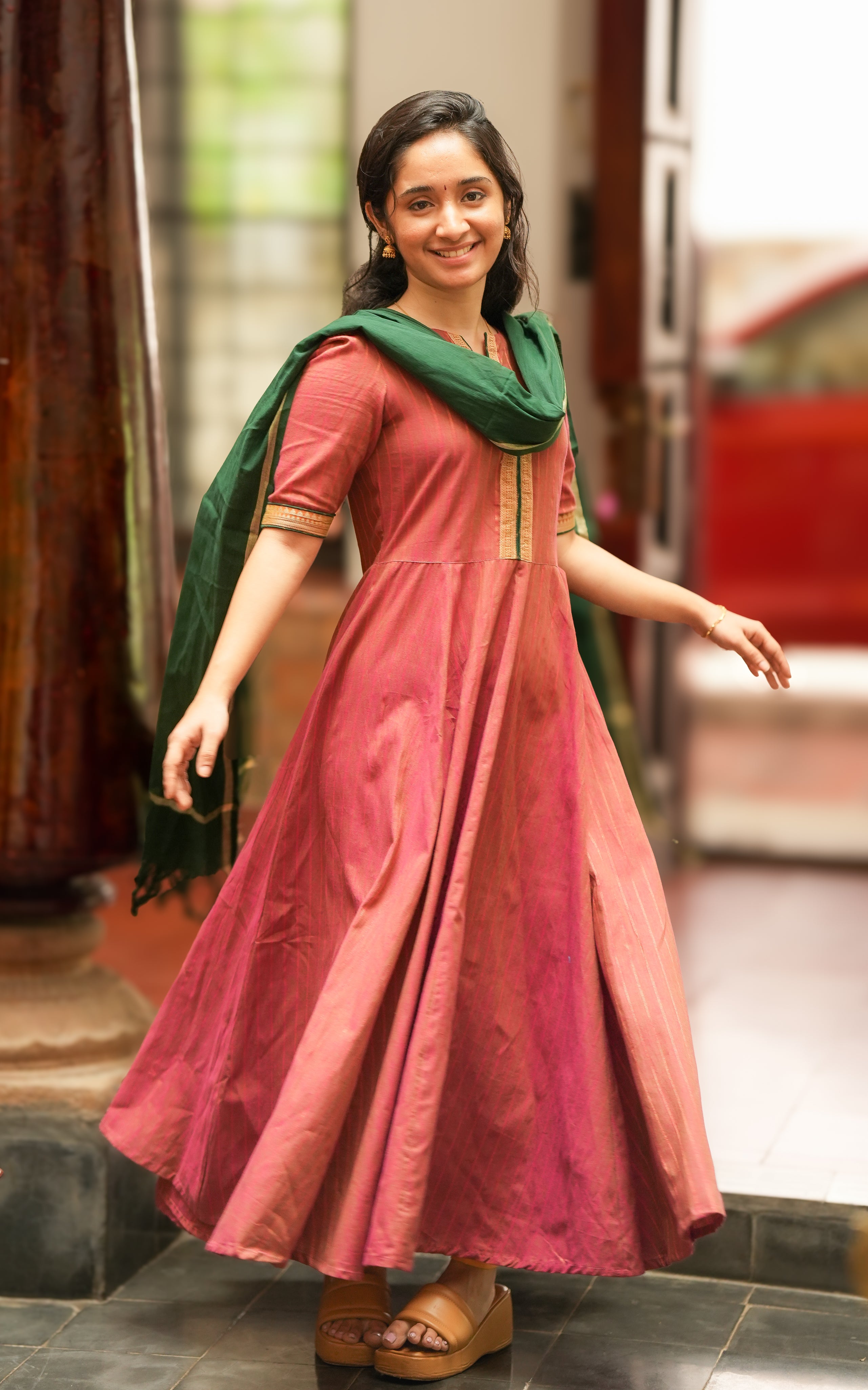 The woman is wearing a deep pink Anarkali-style kurti, inspired by Annapoorani movie 