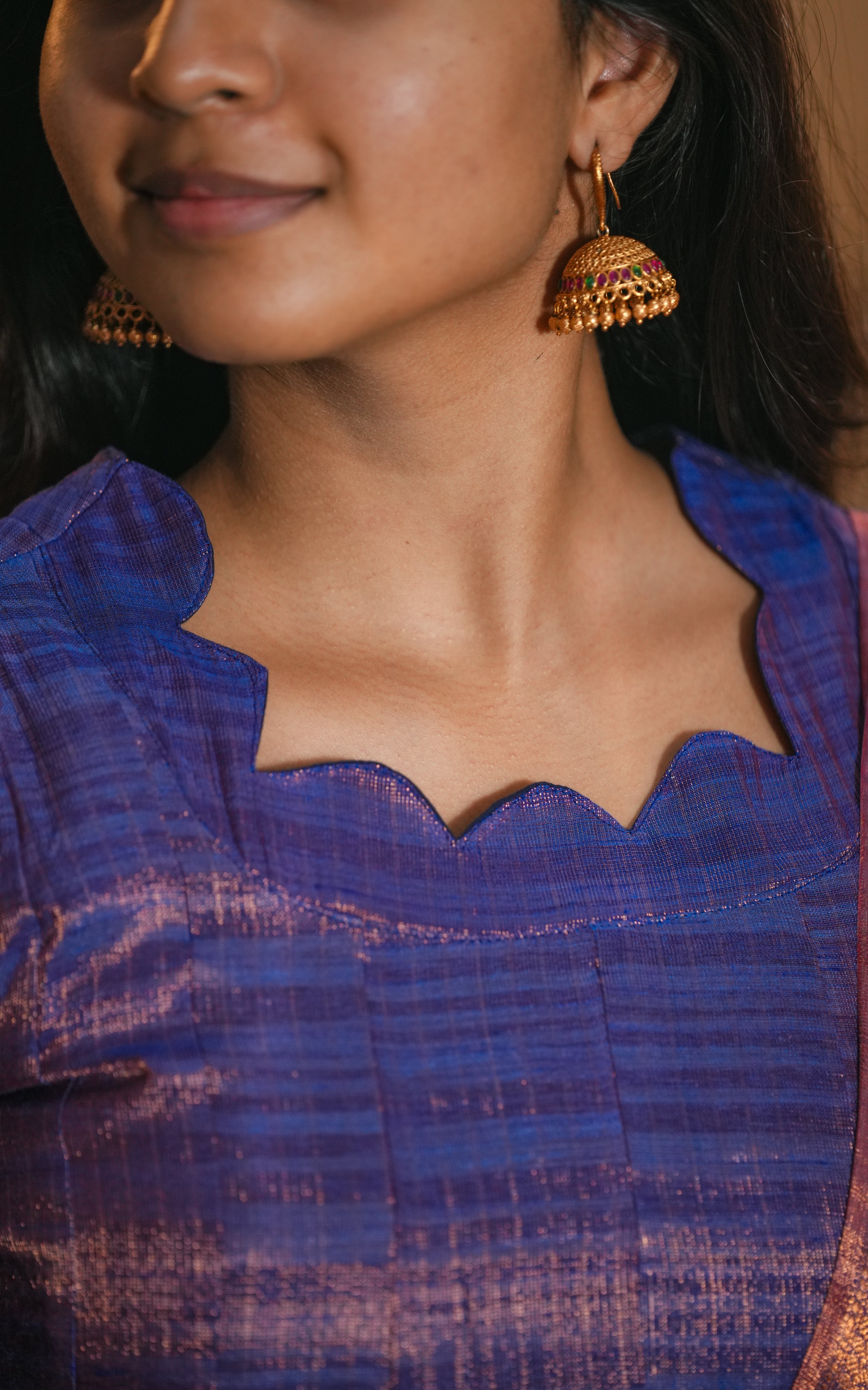 Rich violet and copper hues in the dupatta create a luxurious contrast.