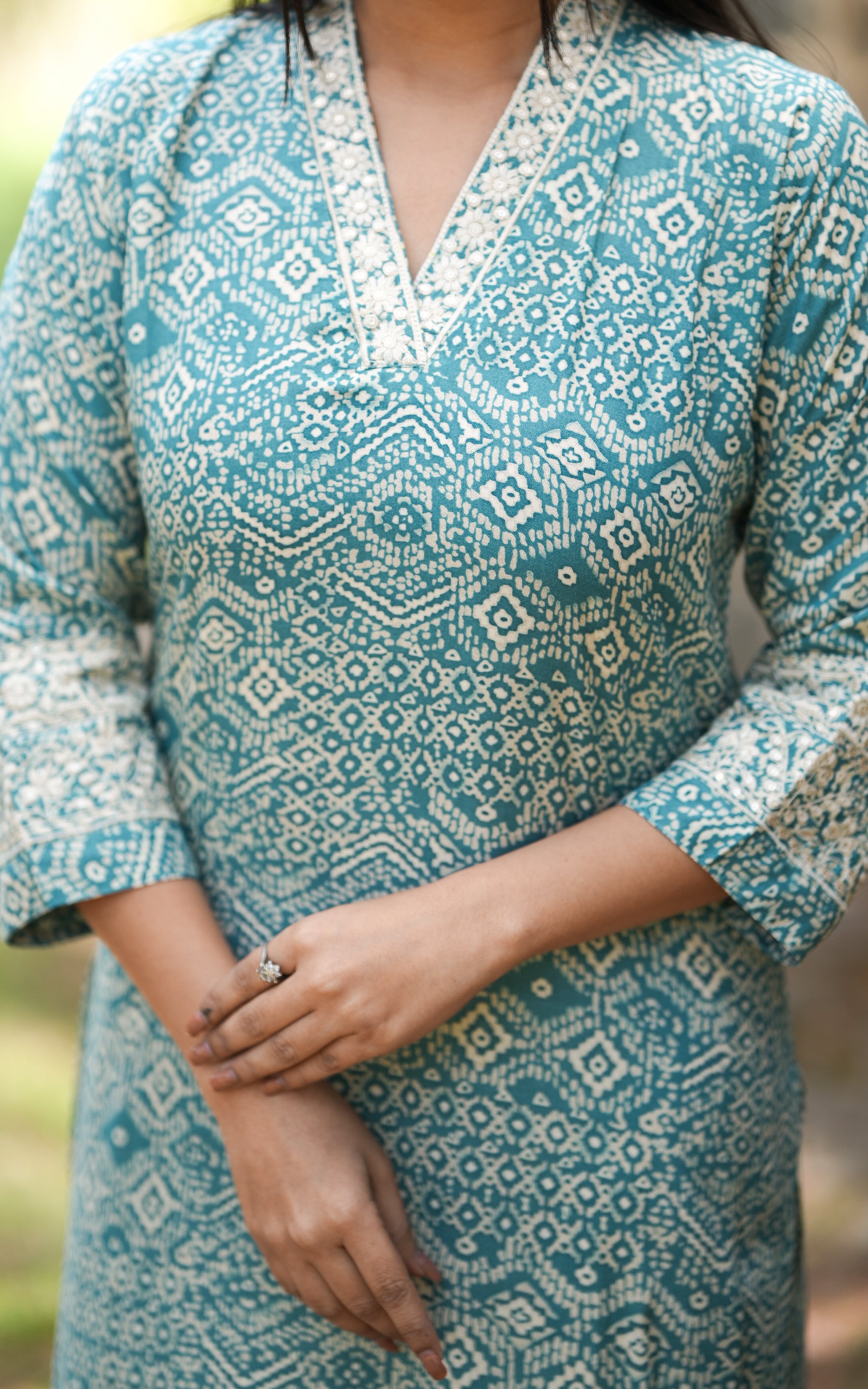 printed chiffon with v neck collar in silver worked design in teal blue colour printed chiffon fabric 3/4th sleeves 