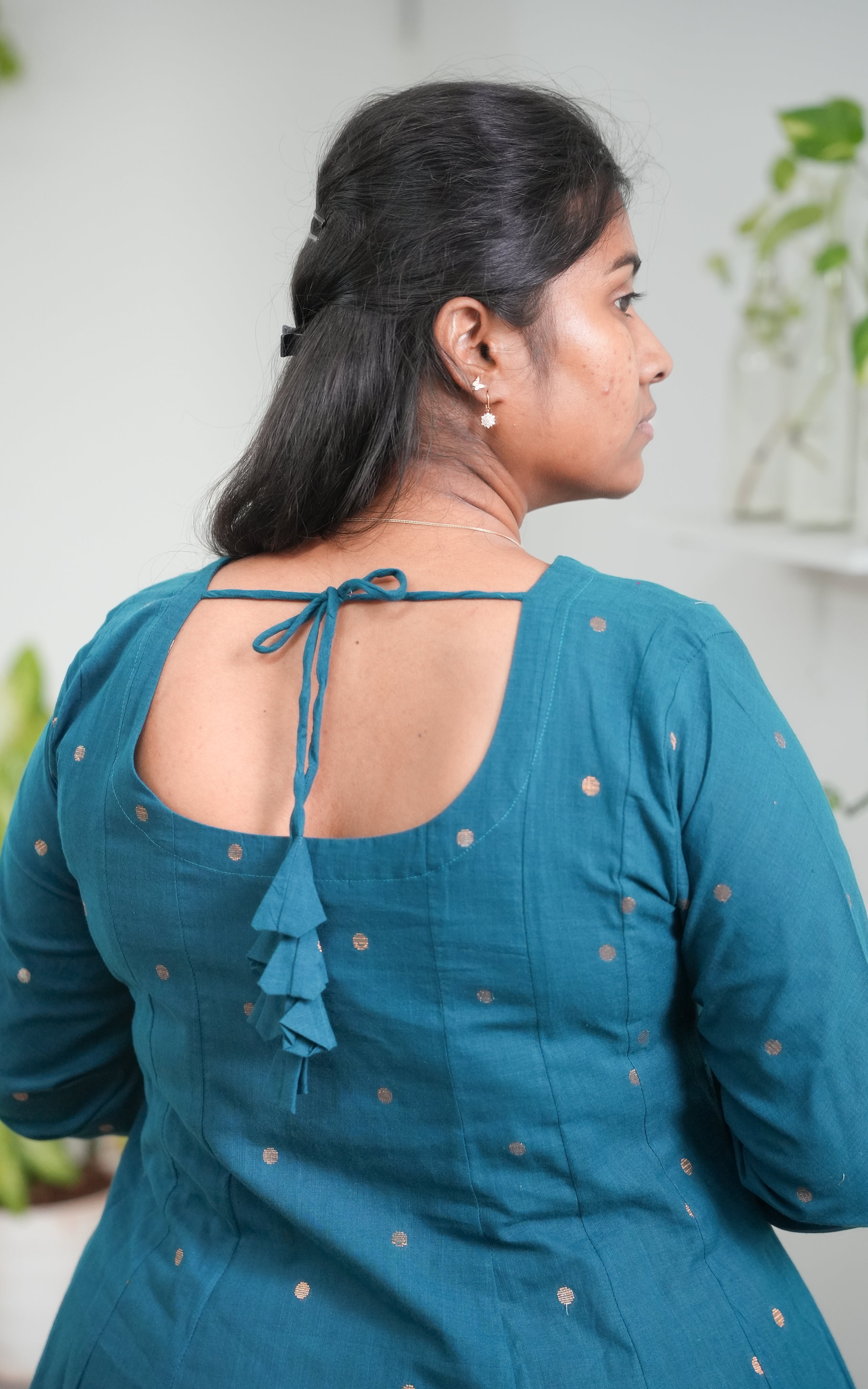 design gives this kurti a refined, feminine charm the back tie knots not only secure the fit but also elevate the outfit's aesthetic, 