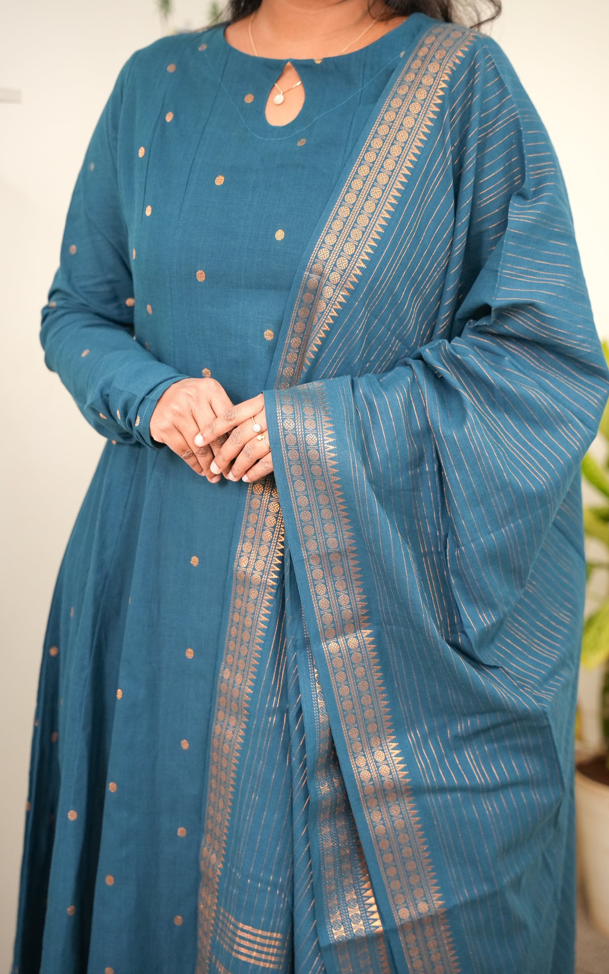 a keyhole neckline, adding a graceful and elegant touch to the overall silhouette