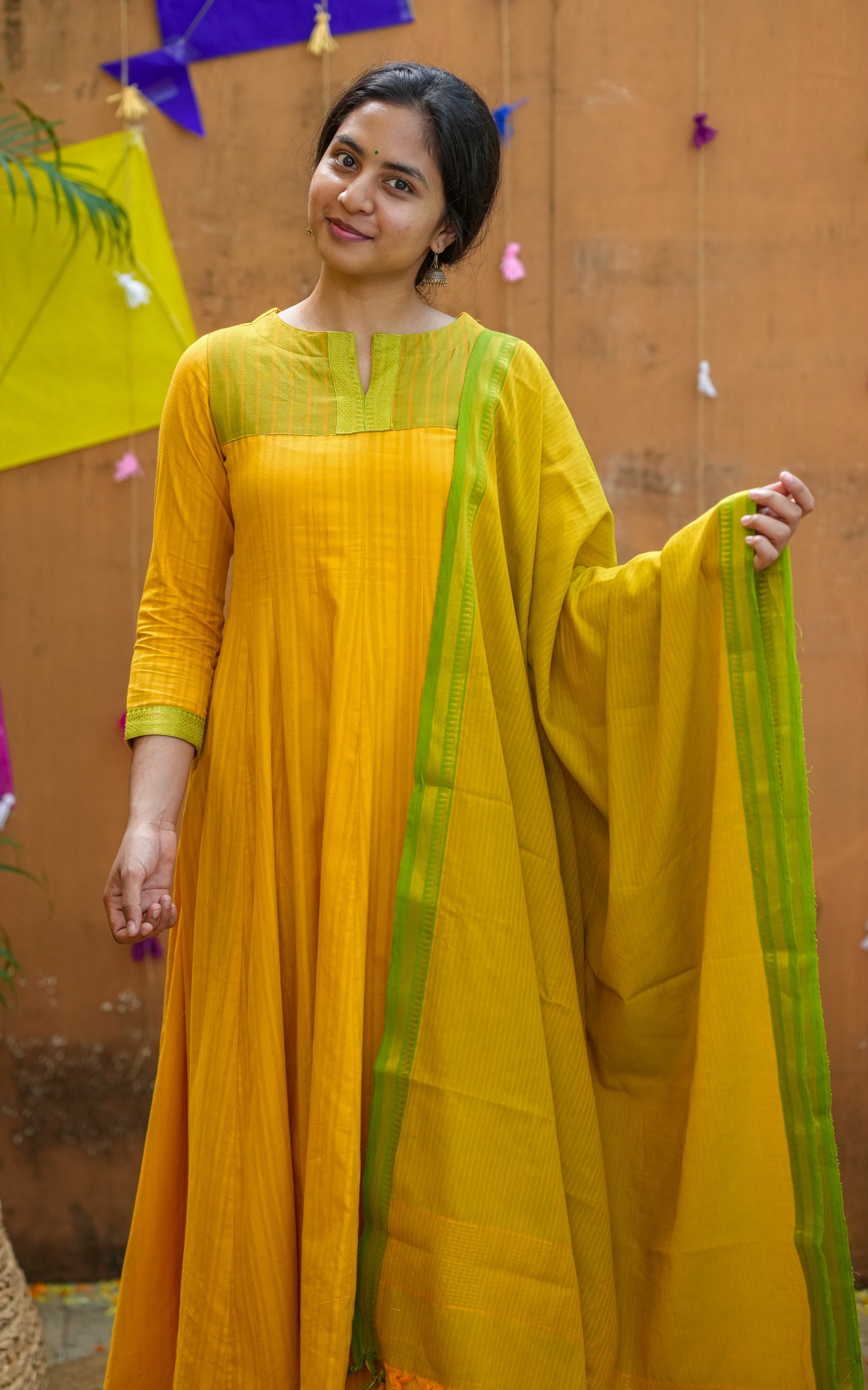 Woman wearing a yellow and green traditional Outfit
