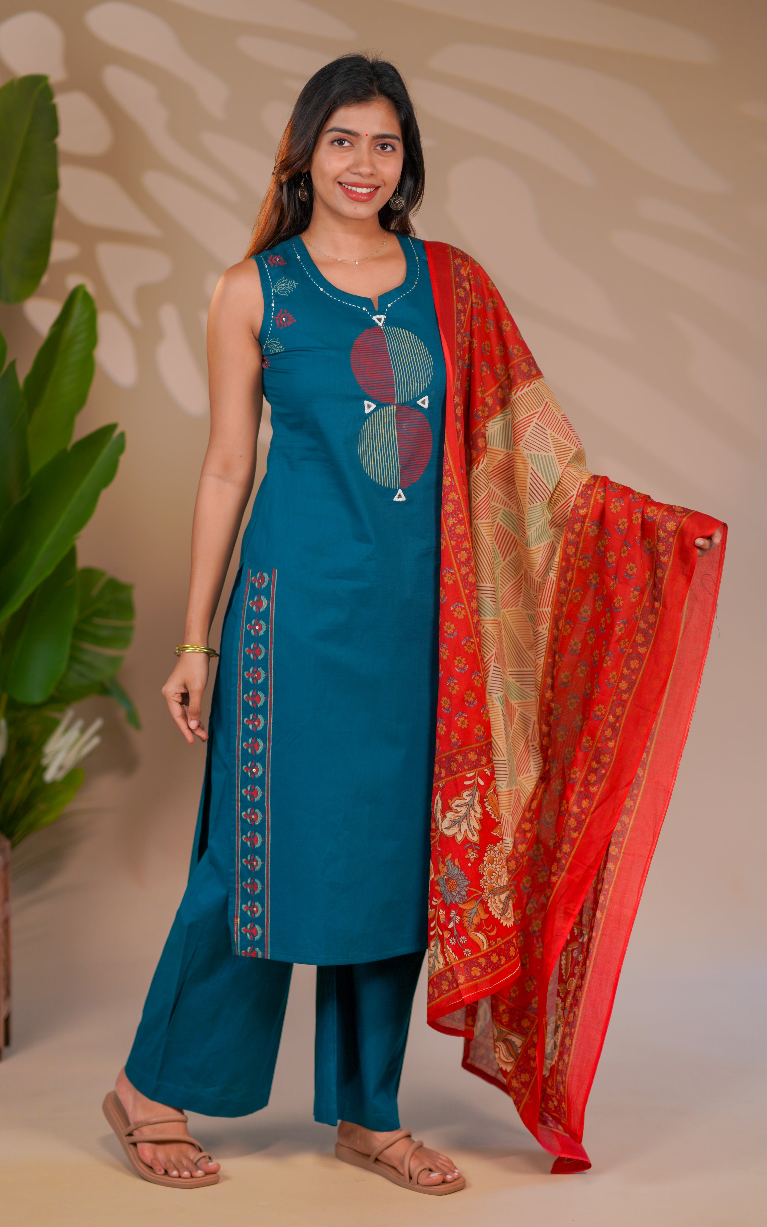 Teal sleeveless straight-cut kurta designed with bold geometric embroidery for a standout look.
