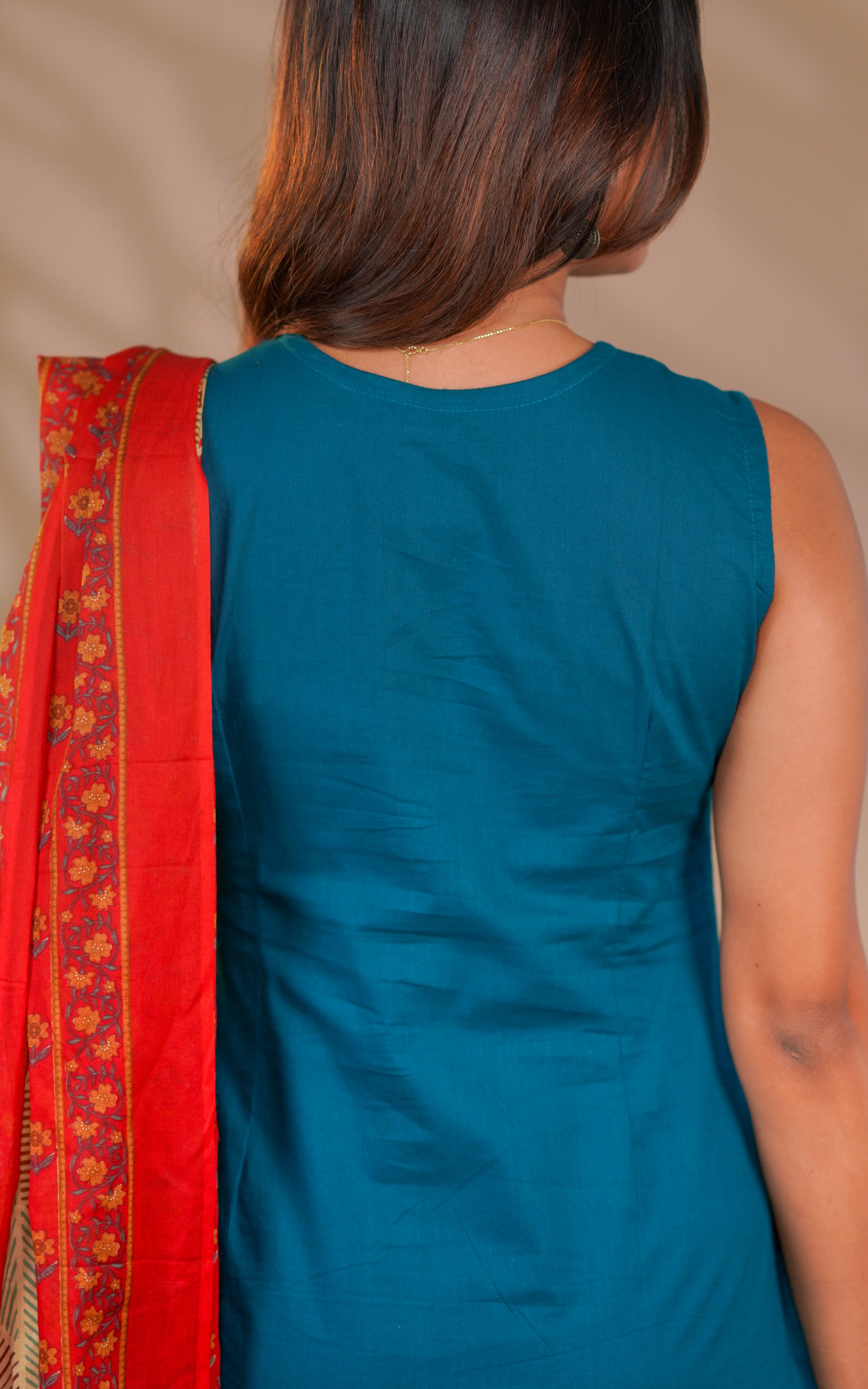 Matching teal straight-fit pants give a clean and polished finish.