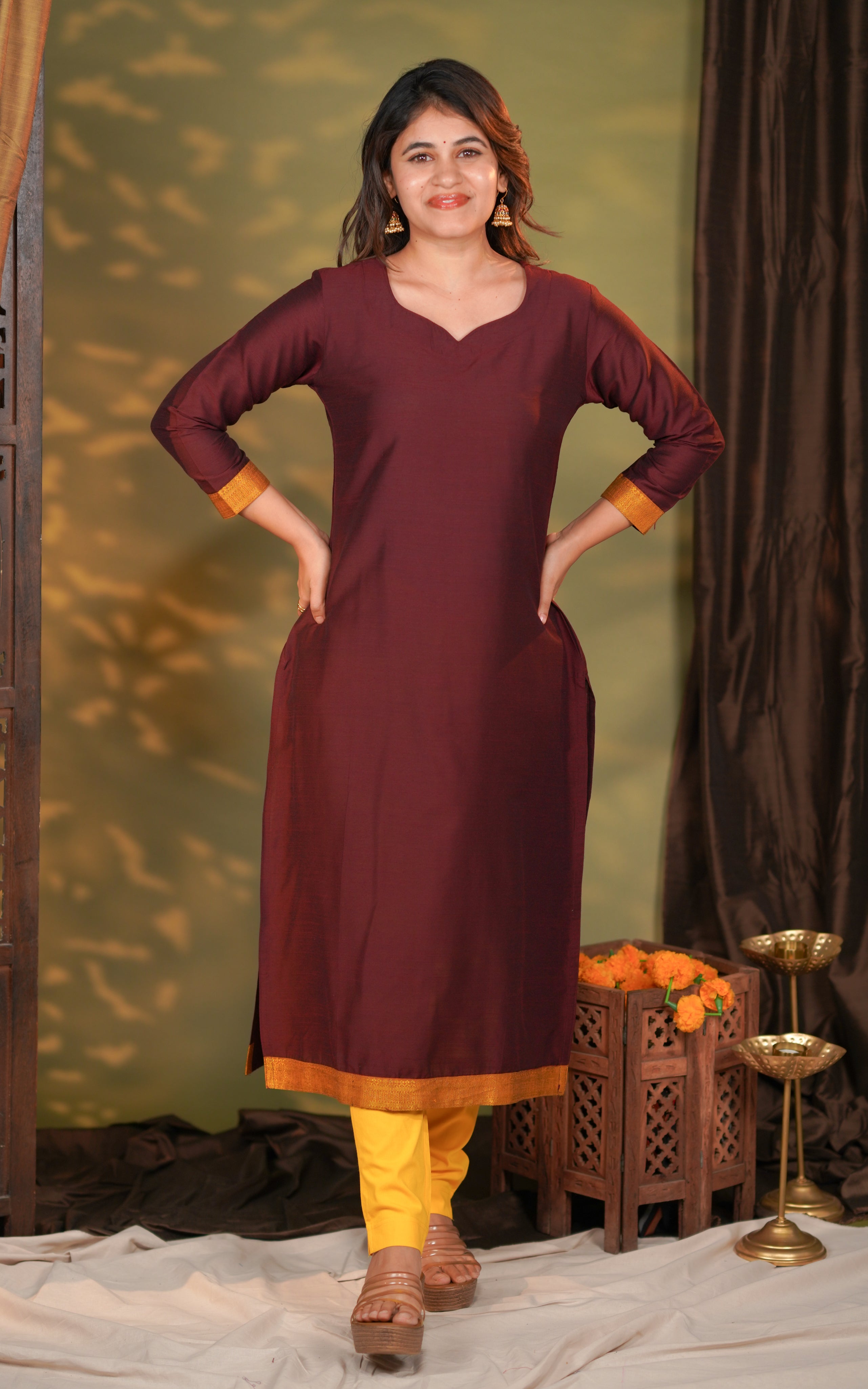 three-fourth sleeves are finished with a rich golden contrast border for an elegant festive appeal.