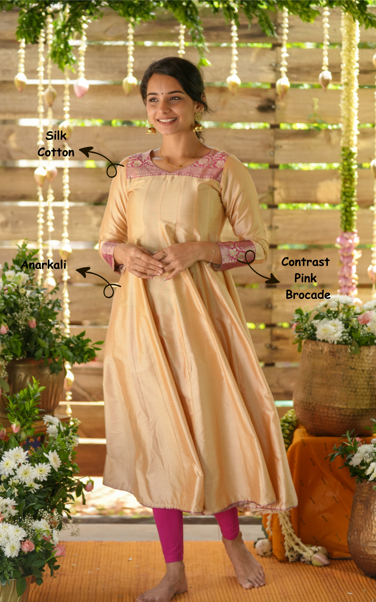 Woman wearing a beige anarkali with pink brocode