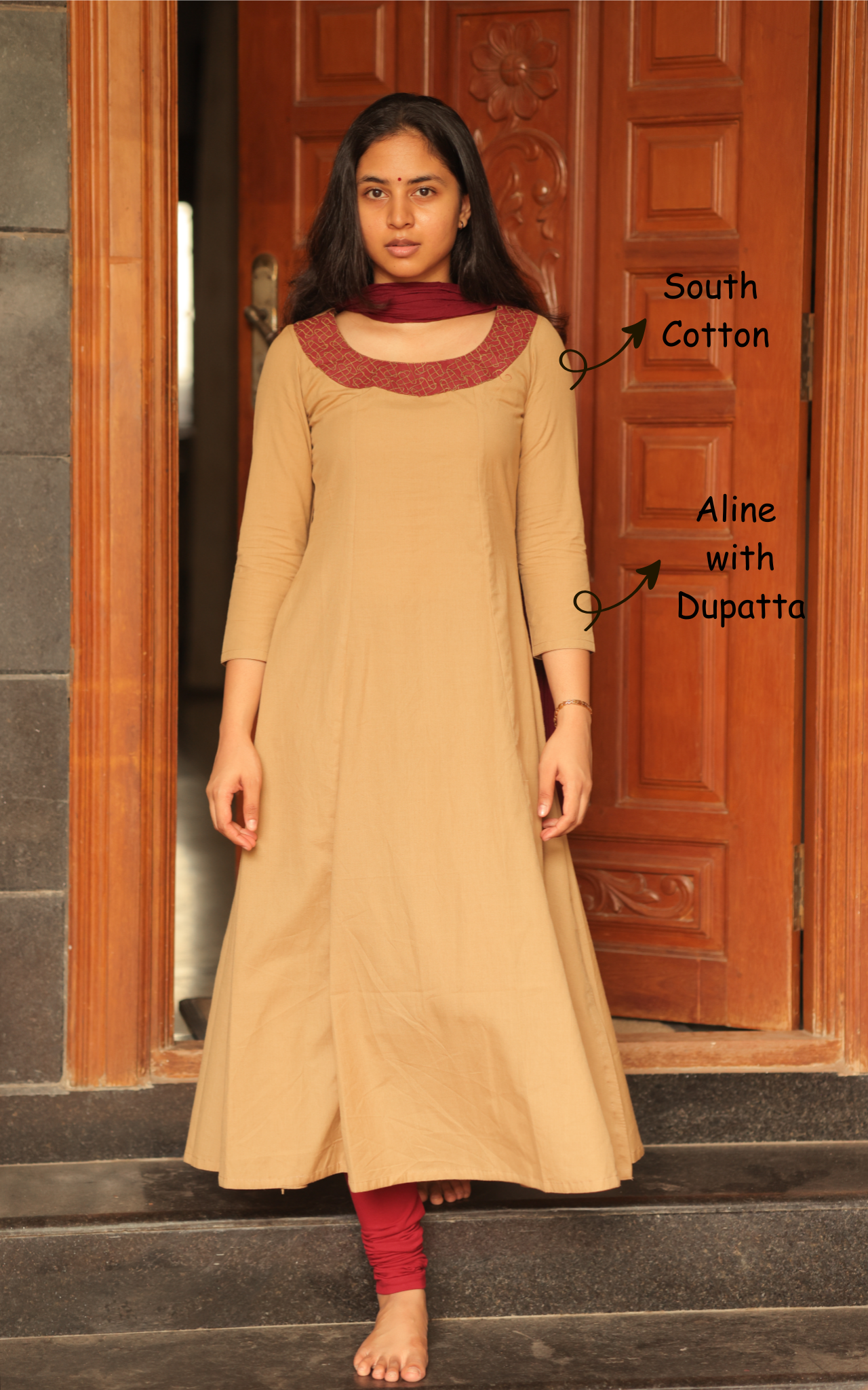 Woman wearing a beige kurta with maroon dupatta 